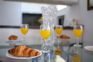Delicious croissant with orange juice, selective focus