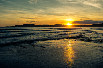 Nascer do sol na praia em Itapema com nuvens e ondas - Paisagem natural
