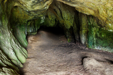 The entrance part of the cave with dirt on the floor.