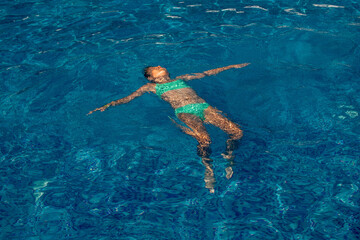 child swimming in the pool