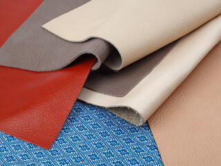 Natural leather textures samples on blue fabric background