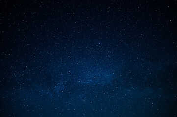 Dark blue night sky and small twinkling stars. Abstraction. Minimalism. There is no one in the...