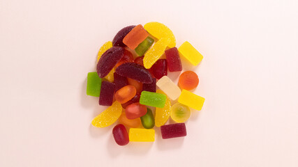 Fruit gummy or jelly candies on a pastel background top view