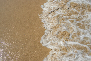 Waves reaching the sand of a beach