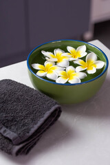 Beautiful spa composition with plumeria flowers in water.