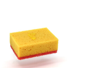 Yellow sponge for dishes on a white background with a shadow