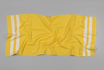 Fototapeta na wymiar Crumpled yellow beach towel on light grey background, top view