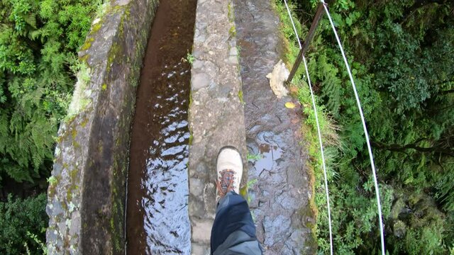 POV shot of a man hiking a levada trail on Madeira island, Portugal