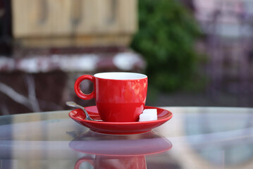 Red cup of coffee on the table