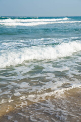 Sea or ocean tropical landscape view. Sea waves under the sun. Summer vacation and travel concept. Water wave surface. Sand beach. 