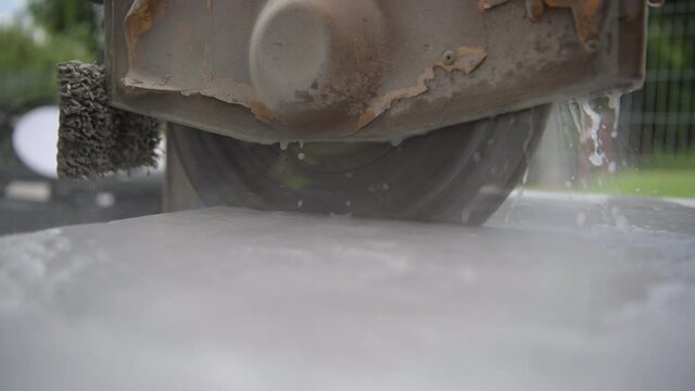 Process of Cutting Concrete Path Tiles Using Powerful Electric Circular Concrete Saw