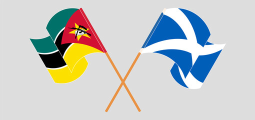Crossed and waving flags of Mozambique and Scotland