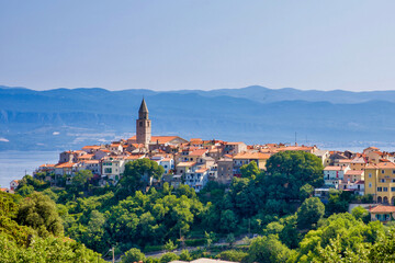 view to the town of vrbnik with mountains in the background