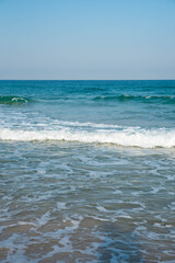 Sea or ocean tropical landscape view. Sea waves under the sun. Summer vacation and travel concept. Water wave surface. Sand beach. 