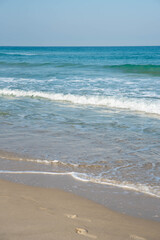 Sea or ocean tropical landscape view. Sea waves under the sun. Summer vacation and travel concept. Water wave surface. Sand beach. 