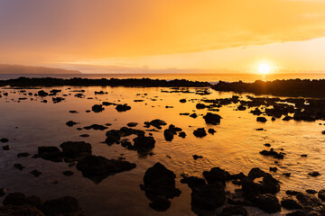Fototapeta na wymiar Sunset reflection over Hawaiian beach