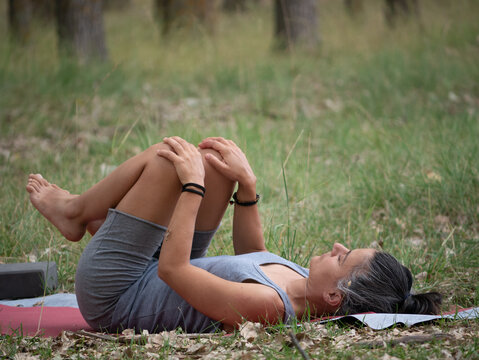 Woman Doing Yoga Outdoors Apanasana