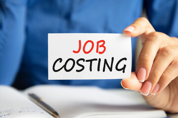 job costing written on a paper card in woman hand
