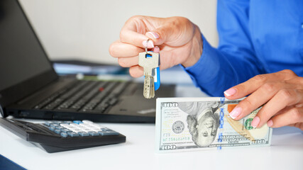 woman holding keys to apartment and money