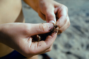fishing skills close-up. a fisherman puts a worm on a hook