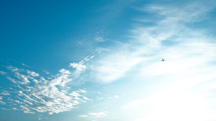 Naklejka na ściany i meble cloudscape background. travel template for text and design. lonely plane in the blue sky