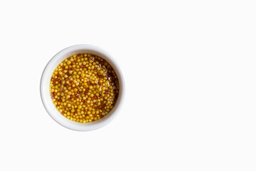 Whole grain french mustard in a jar isolated on white background with copy space