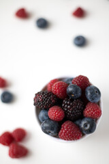 Fresh summer berries on white background - top view