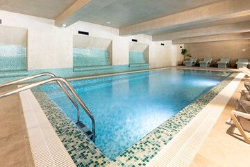 Indoor swimming pool in hotel wellness center