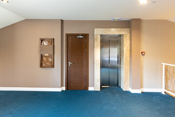 Stainless steel elevator door in hotel corridor