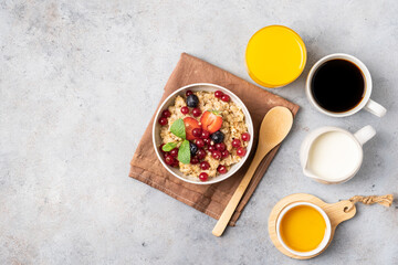 Breakfast table with pancakes, granola, fresh berries and orange juice. Top view.