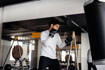 Boxing, a healthy lifestyle. An athlete trains in the gym. A man does endurance exercises and cardio.