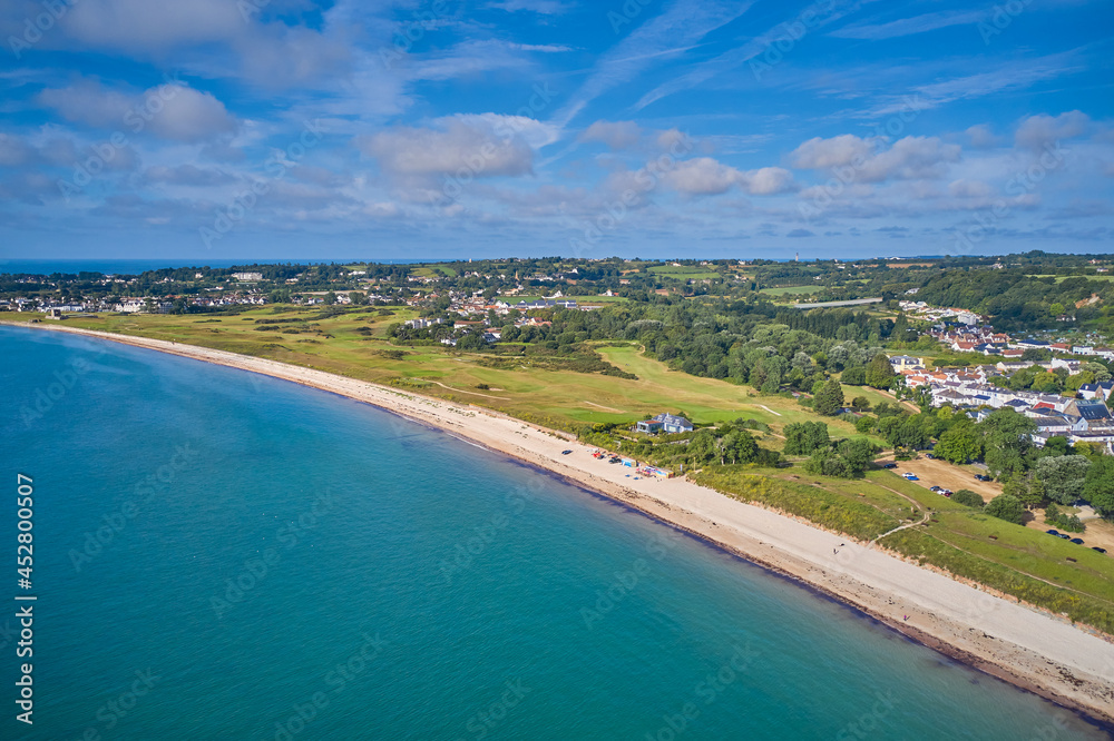 Wall mural Aerial drone image of Grouville Bay with calm sea, golf course and landscape. Jersey CI