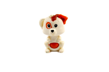 Small toy dog on a white background. Plastic toy