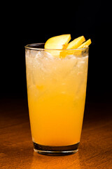 Peach fizz cocktail at the bar on wooden background