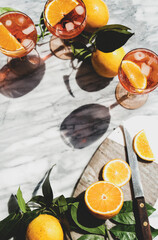 Aperol Spritz cocktail in glasses with oranges, top view, copy space
