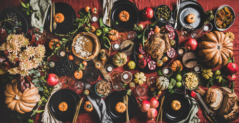 Flat-lay of Thanksgiving celebration dinner table with readitional Autumn food