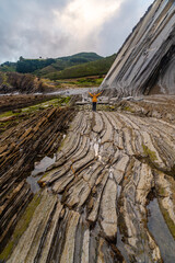 woman with yellow raincoat in a flysch