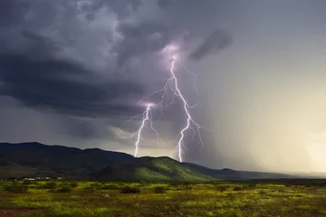 Fotobehang Lightning storm over a mountain © JSirlin