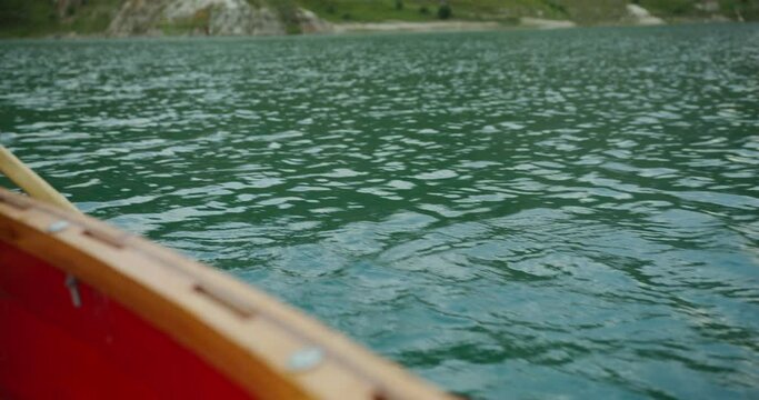 Russia, Caucasus. A man is, rowing an oar in a boat Close up