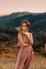 beautiful young elegant woman outdoors at sunset - 452808765
