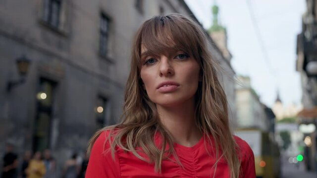 Portrait Of Beautiful Girl In City. Pretty Girl In Red Dress With Long Hair.