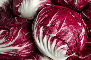 Obraz premium Whole fresh ripe radicchios as background, closeup