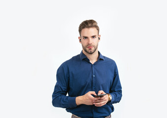 new technology. unshaven guy type message. online business. man with wireless headphones and phone.
