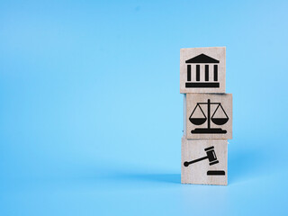 Justice icon on a wooden cube over blue background