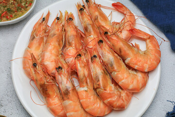 Fresh boiled big sea shrimps (prawns) with spicy seafood sauce and rice. Healthy food. Cooked steamer food served seafood.