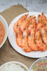Fresh boiled big sea shrimps (prawns) with spicy seafood sauce and rice. Healthy food. Cooked steamer food served seafood.