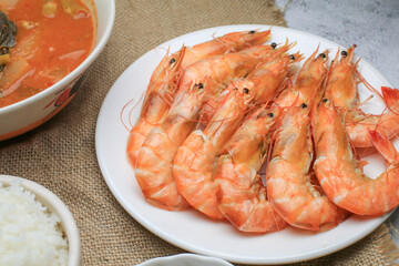 Fresh boiled big sea shrimps (prawns) with spicy seafood sauce and rice. Healthy food. Cooked steamer food served seafood.