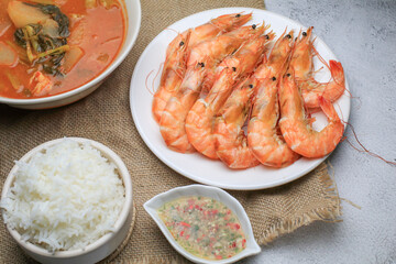 Fresh boiled big sea shrimps (prawns) with spicy seafood sauce and rice. Healthy food. Cooked steamer food served seafood.