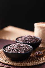 Purple glutinous rice grain in a black bowl, Thai rice