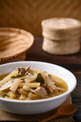Local Thai food, Spicy banana stalk soup with pork in a bowl on wooden table